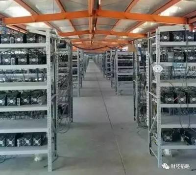 Technician performing maintenance on a liquid-cooled mining farm rig